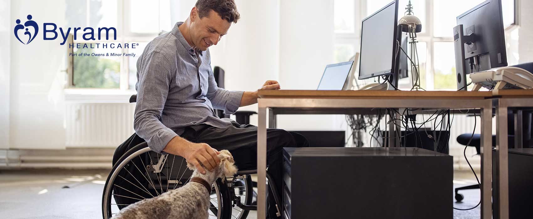 Man in a wheelchair petting his dog
