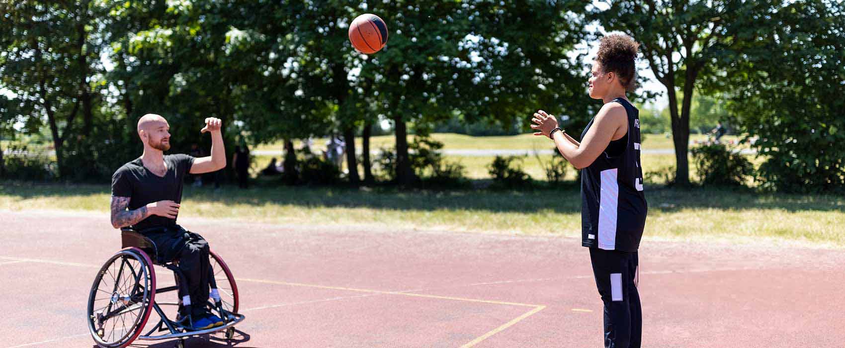 Man in a wheelchair playing basketball.