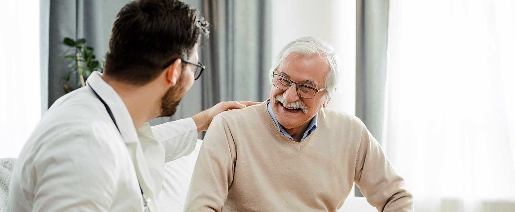 Doctor talking to his smiling patient