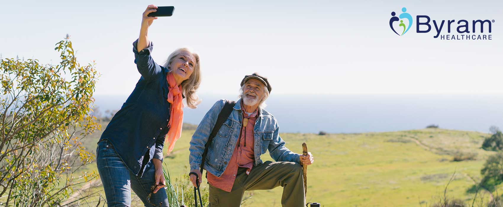 Older man and woman hiking and taking a selfie.