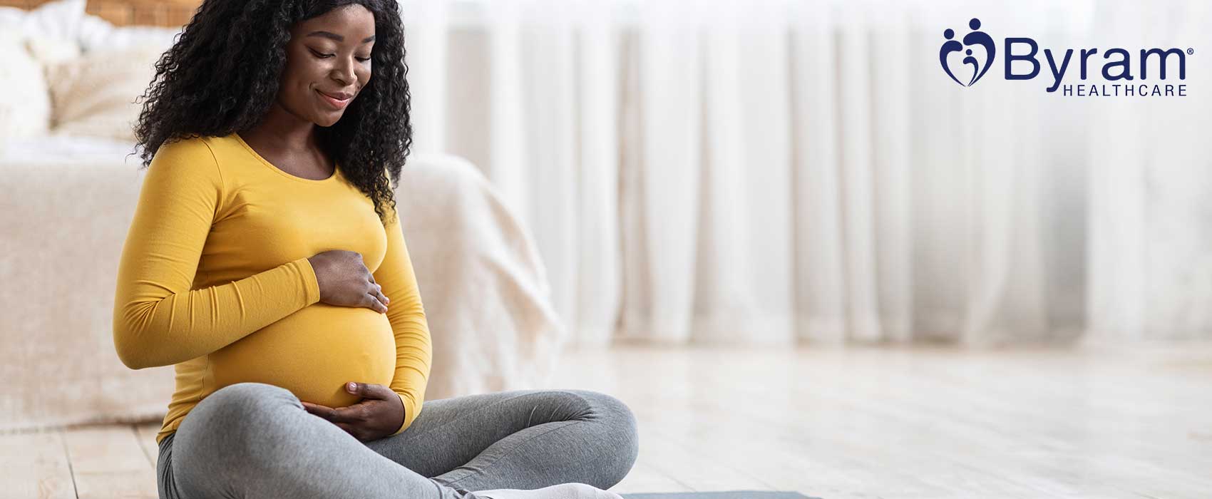 Pregnant woman touching her baby bump.