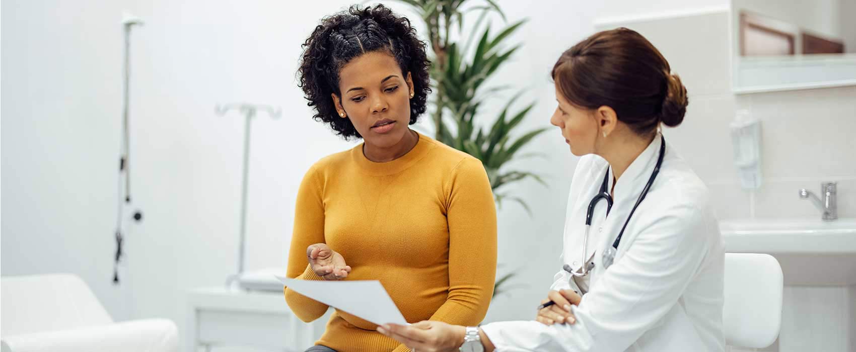 Woman asking her doctor questions.