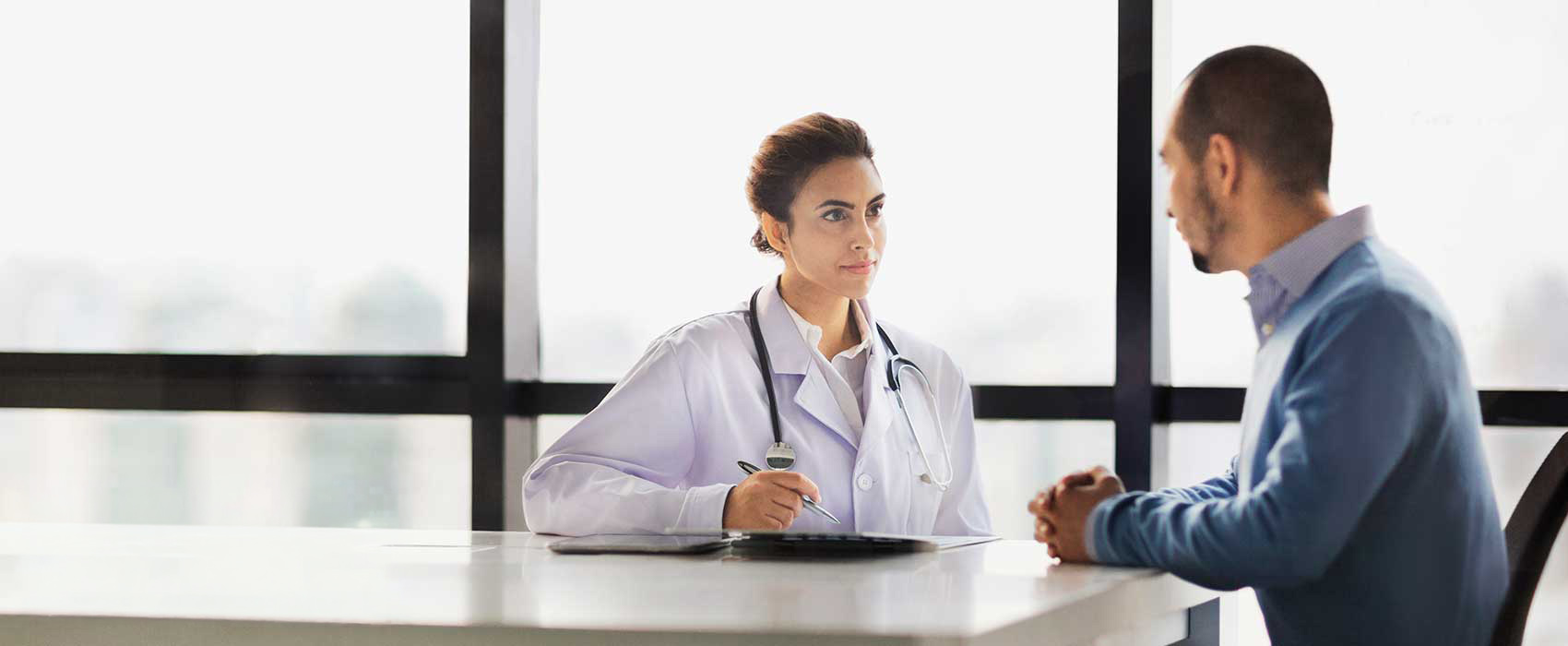 a man at a table talking to his doctor