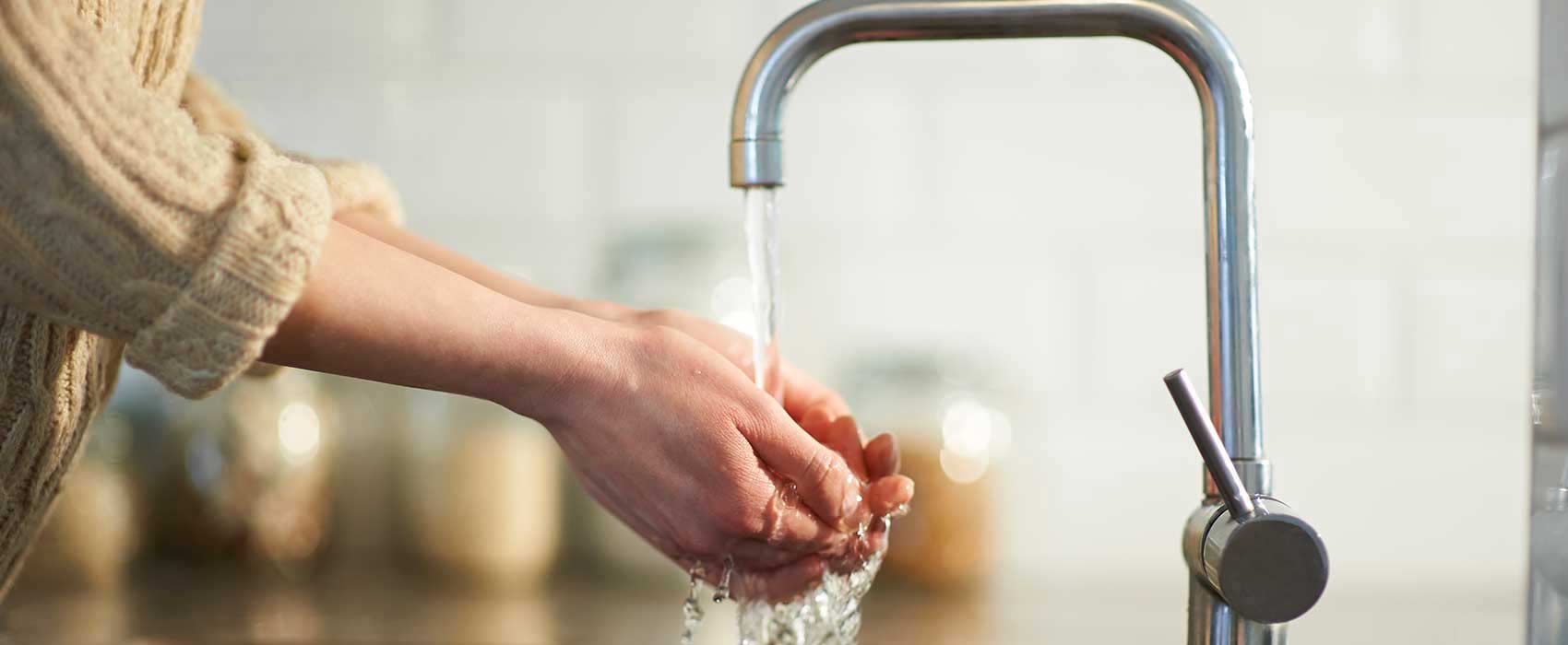 Woman washing her hands.