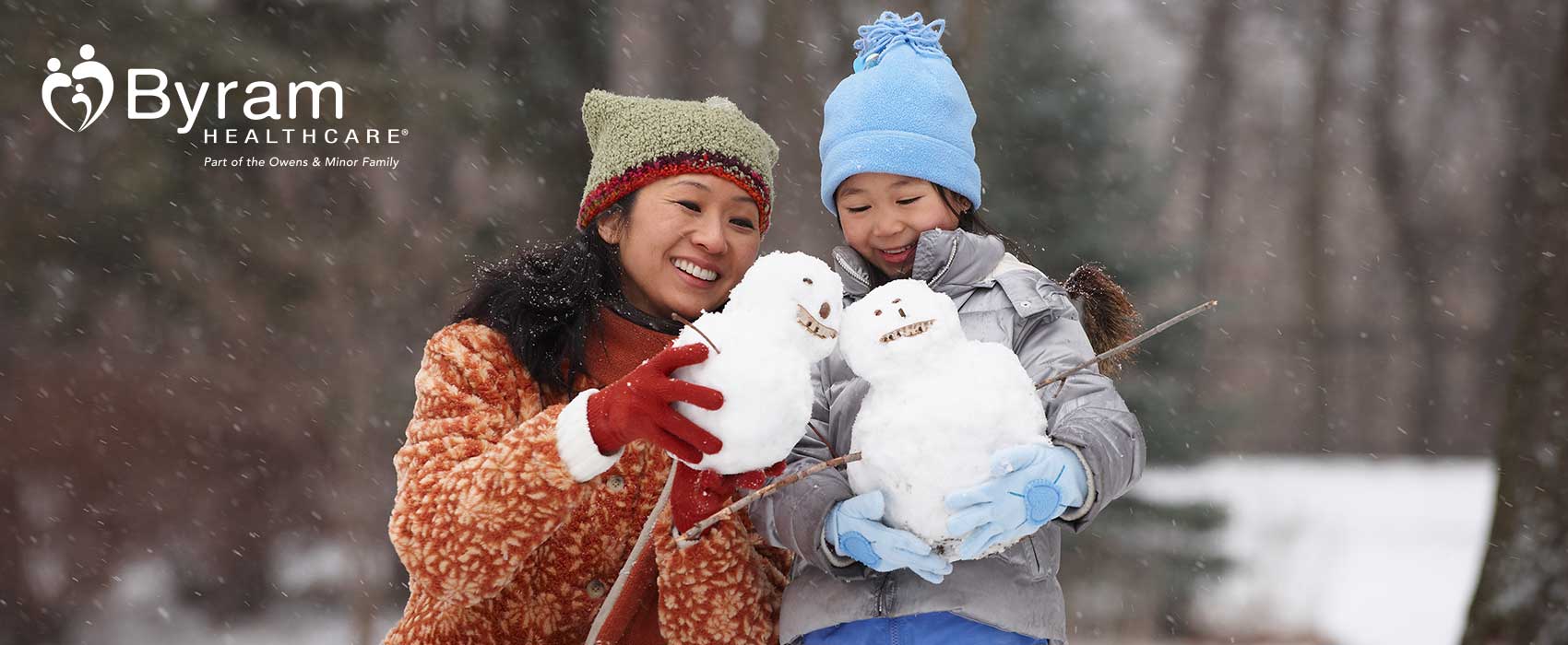 Mom and daughter building snowmen