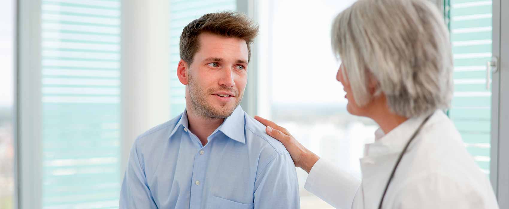 Doctor touching patient shoulder.