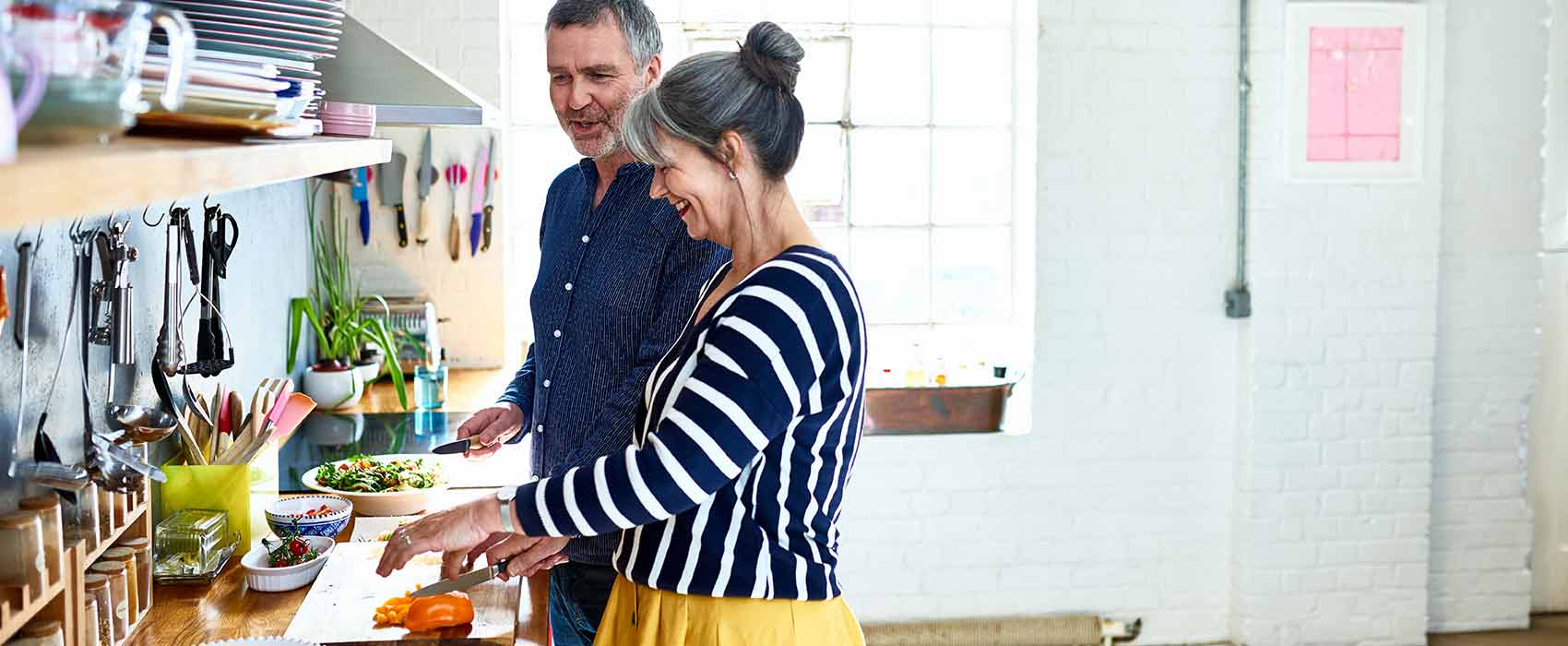 Man and woman cooking in a kitchen.