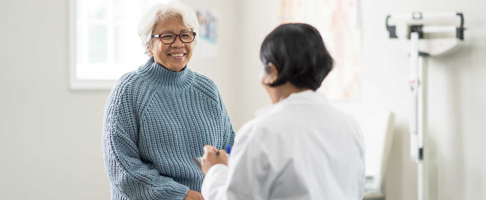 Doctor talking to her older patient.