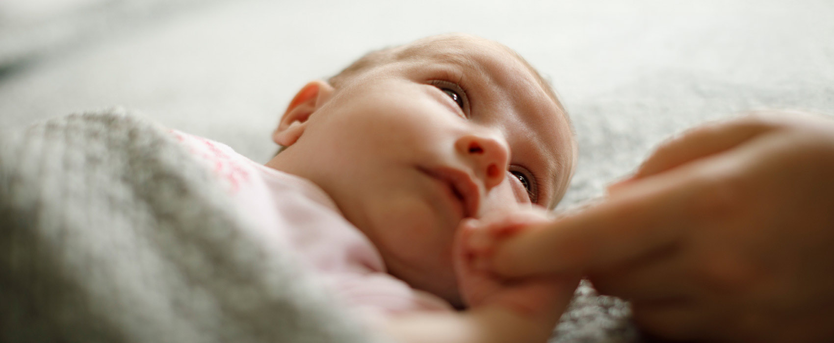 newborn holding finger
