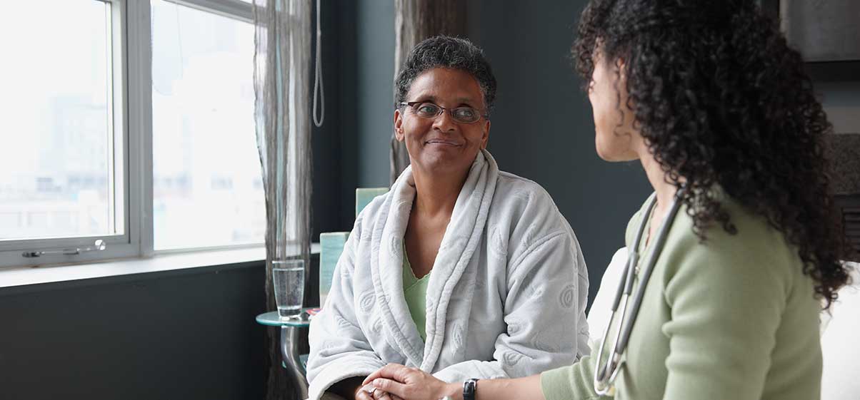 Nurse talking to patient.