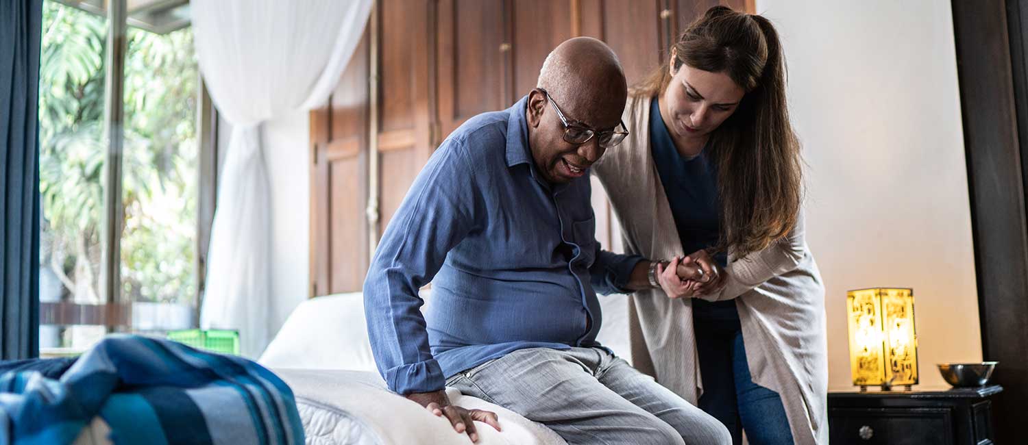 Woman Helping Elderly Man