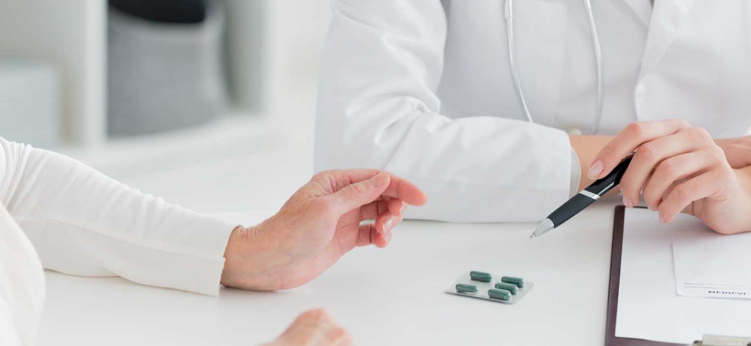 Doctor showing patient medication