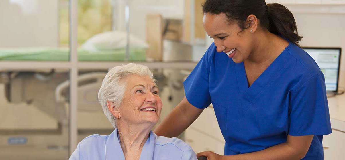 Nurse helping elderly lady