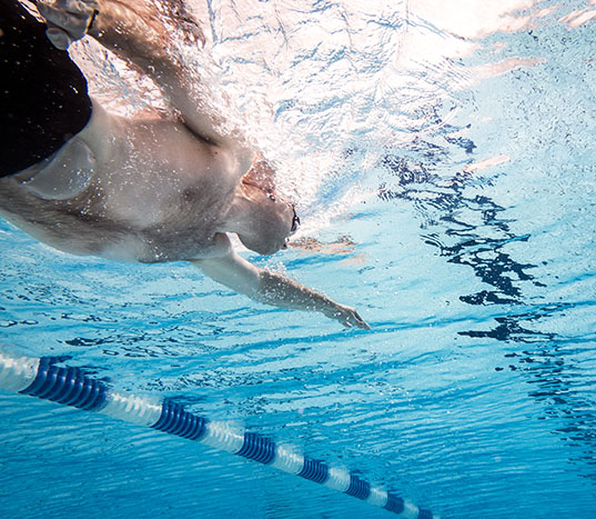 man swimming with ostomy bag