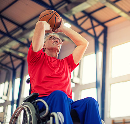 man in wheelchair shooting hoops