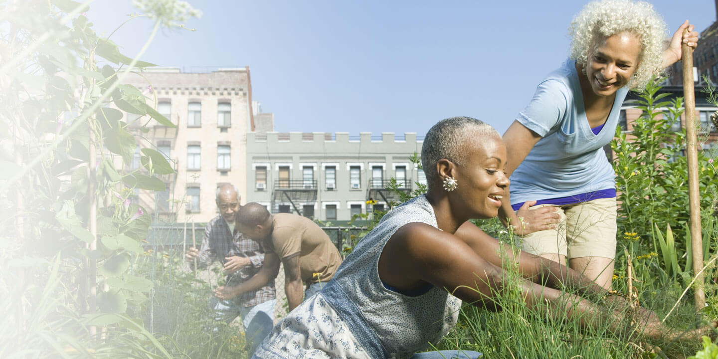 Woman and mom working in city community garden