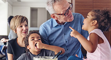 Older man with wife and 2 children in kitchen