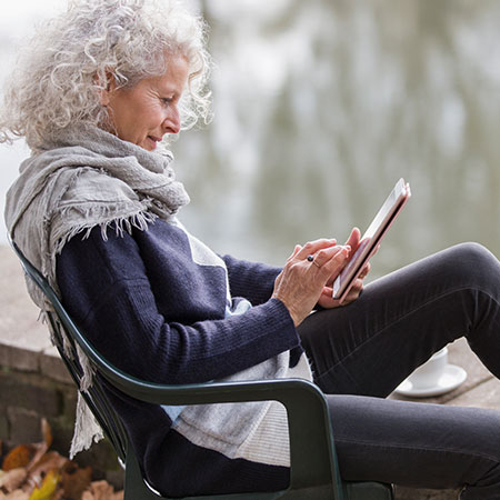 woman sitting using tablet