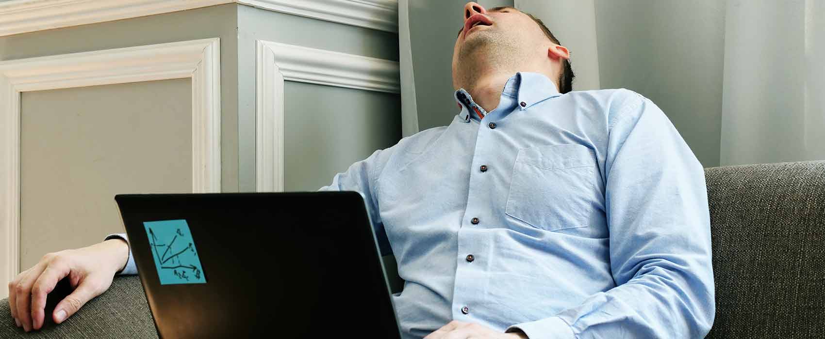 man asleep using laptop