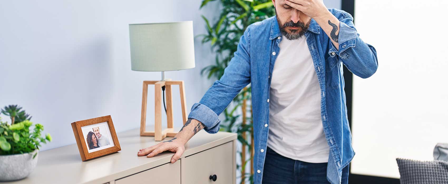 man bracing against furniture