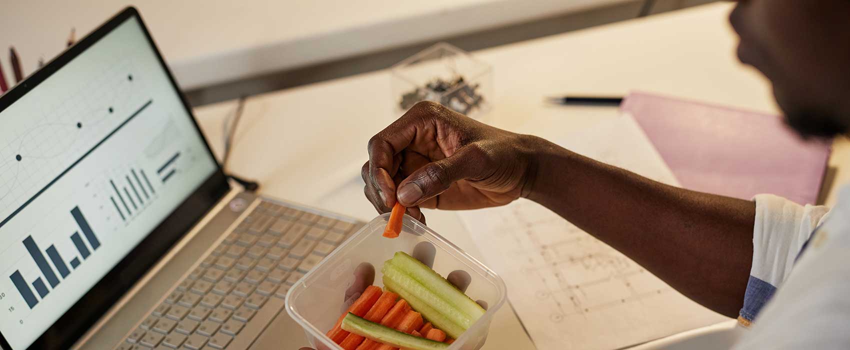 man eating carrots at work