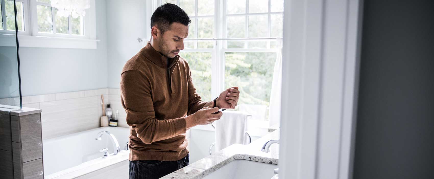 man putting on watch