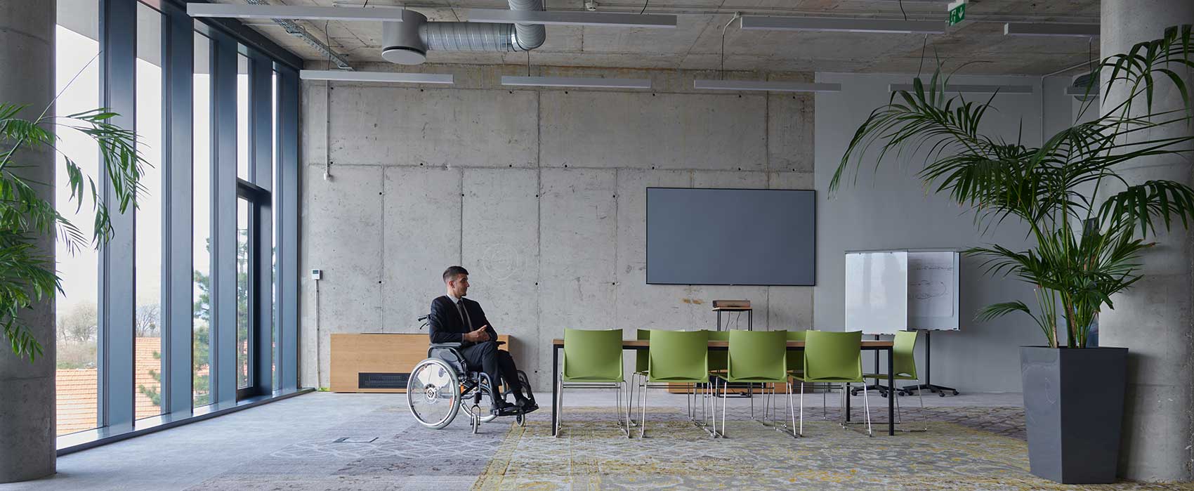 Man in wheelchair in building lobby