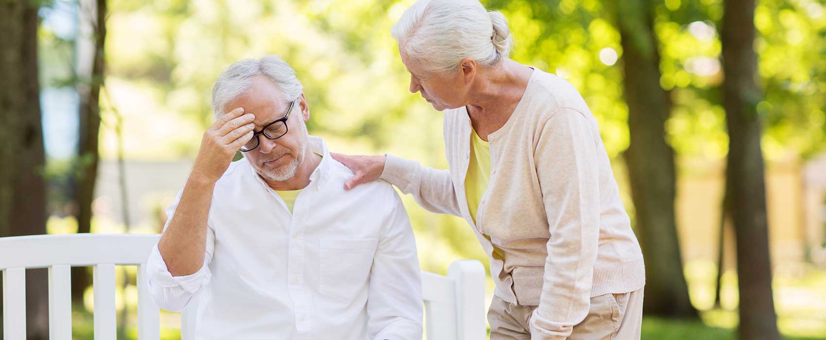 older man and woman at outside bench