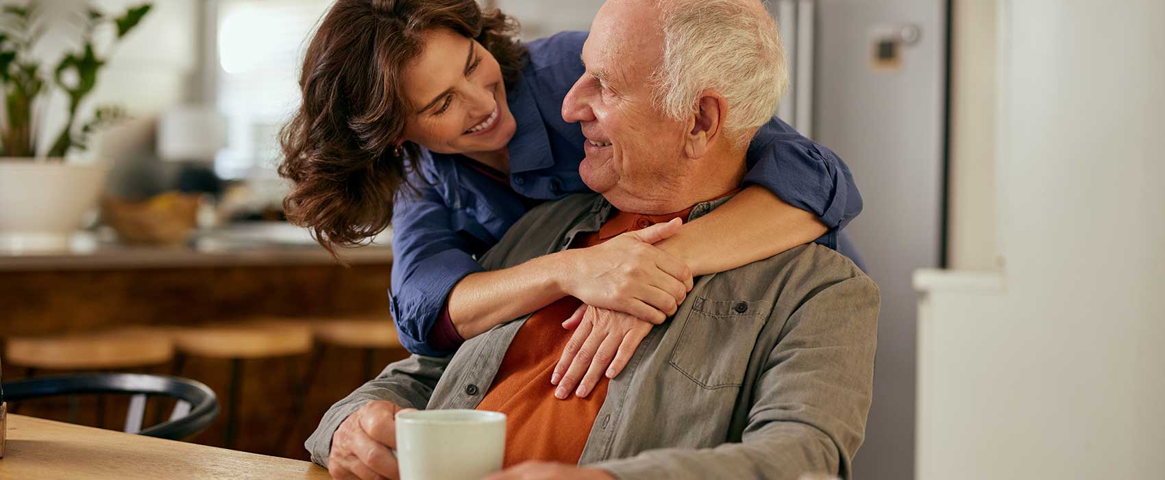 older man and woman at kitchen table
