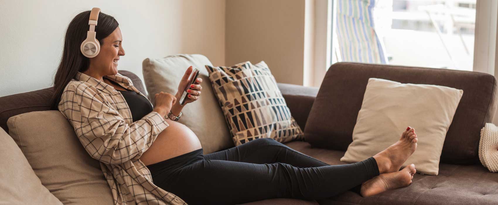 pregnant person listening to music