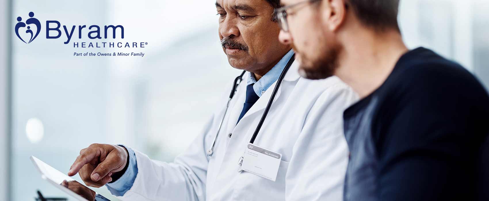 Male doctor going over chart with male patient